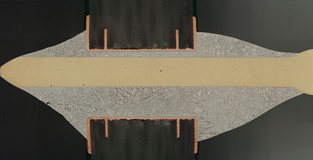 Stitched image of a cross-section of a soldered connector pin